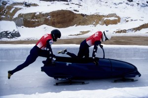 Two man bobsled team pushing off at the start.