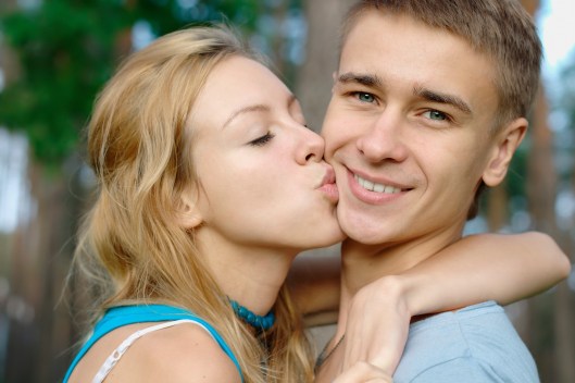 Teenage boy kissed by a girl