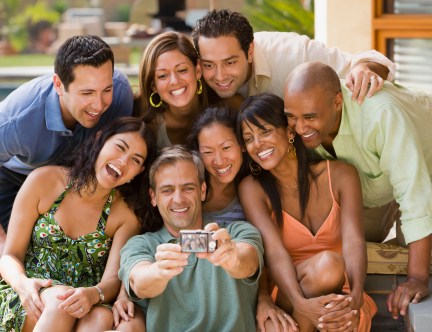 Multi-ethnic friends taking own photograph